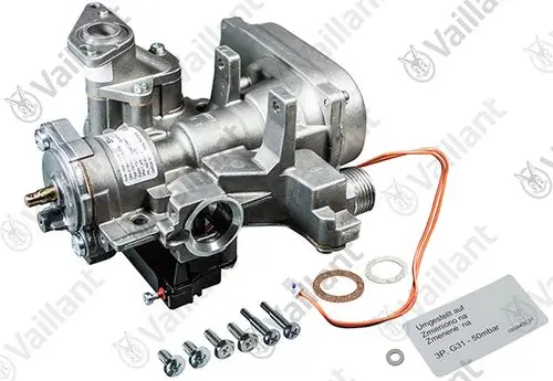 Vaillant Gasarmatur mit einem Gehäuse, mehreren Anschlüssen und elektrischen Komponenten sowie Schrauben und Dichtungen in der Verpackung.